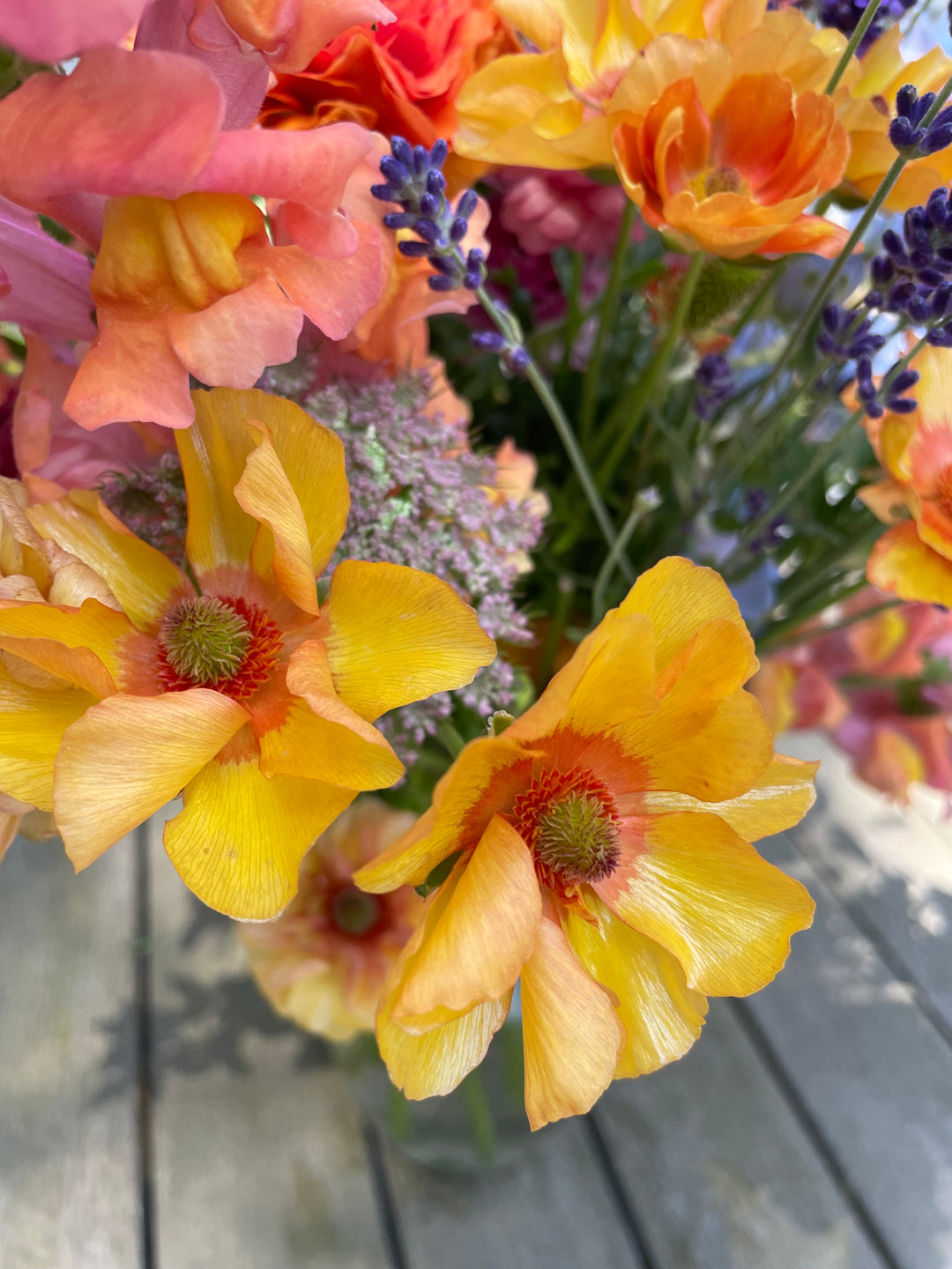 Orange Charis Butterfly Ranunculus in a bouquet