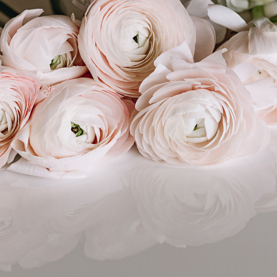 a bunch of pink flowers sitting on top of a table