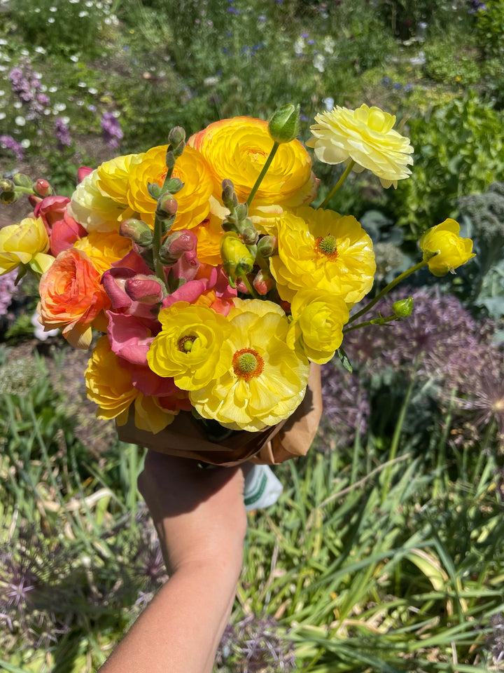 a person holding a bouquet of flowers in their hand