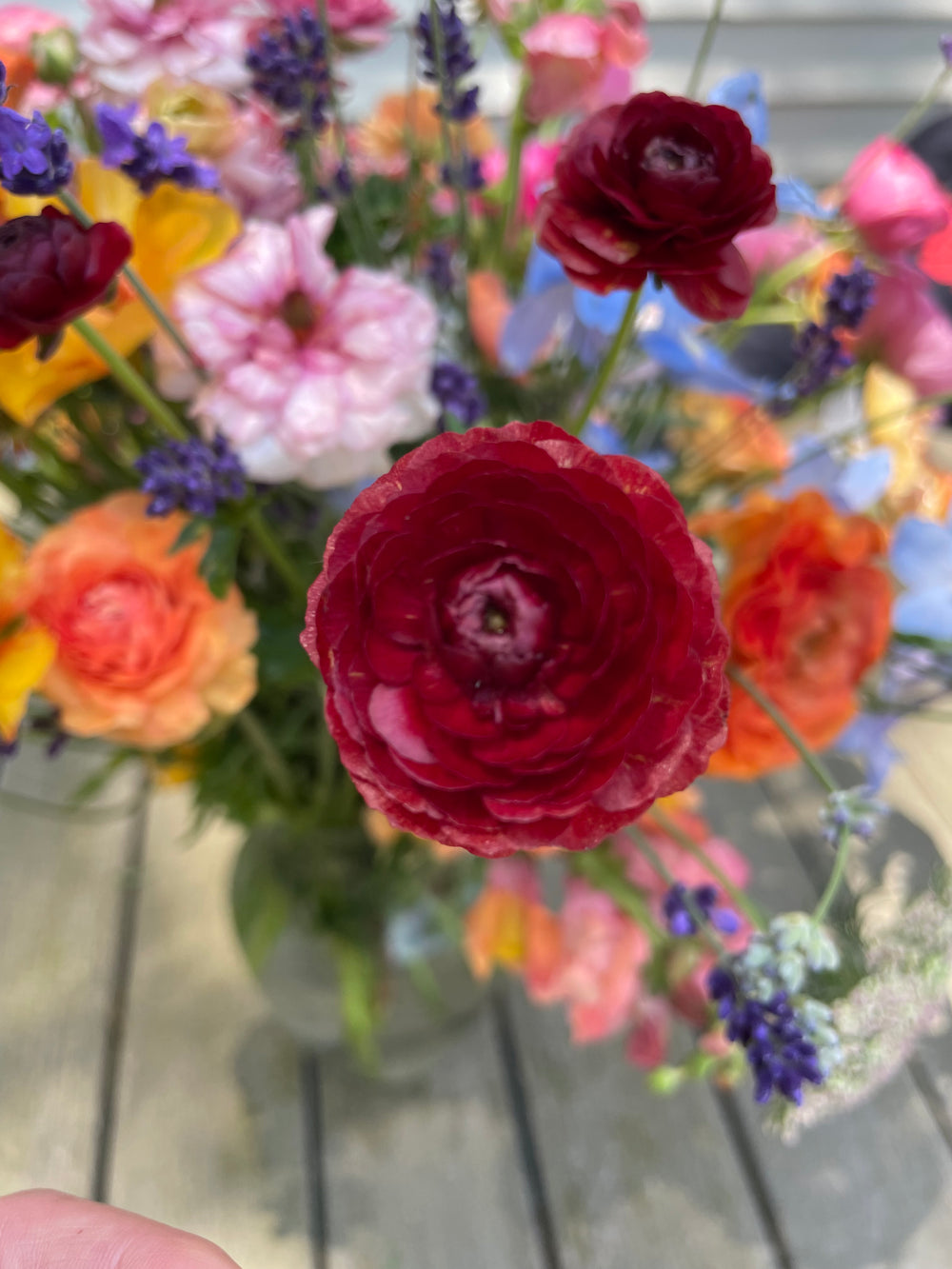 a vase filled with lots of different colored flowers